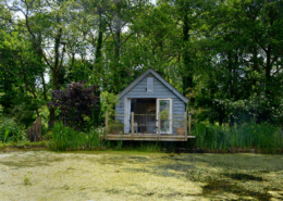 Big Man Tiny Homes – wooden cabin exterior by lake
